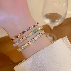 Close-up of colorful zircon adjustable bracelets with geometric stones on wrist