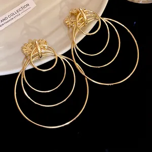 Close-up of multi-layered gold hoop earrings with sparkling rhinestones for women