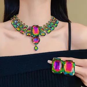 Detailed view of an exaggerated rainbow rhinestone necklace and matching earrings set