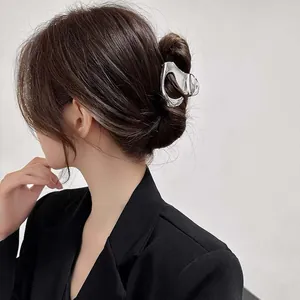 Elegant silver geometric metallic hair claw clip for a sophisticated back bun hairstyle.