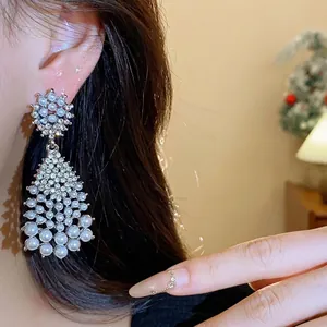 Elegant silver needle tassel earrings with rhinestones and pearls for a vintage look.