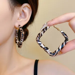 Stylish leopard print leather wrapped geometric hoop earrings with silver needle posts