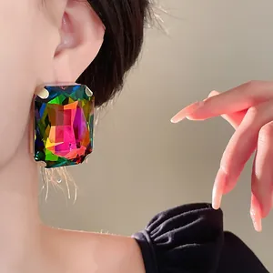 Detail showing oversized iridescent rectangular crystal stud earring with French vintage design