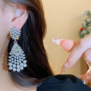 Detailed shot of vintage-style silver tassel earrings with elegant pearls and rhinestones.