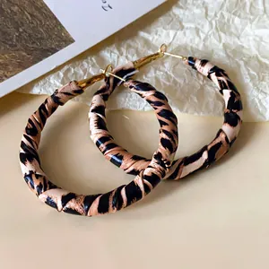 Detailed view of stylish leopard print leather wrapped large hoop earrings for women