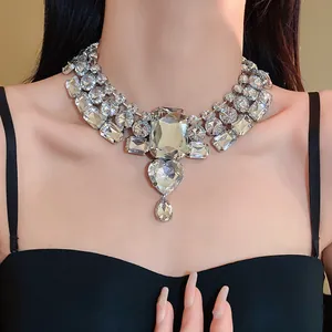 Close-up of a sparkling vintage statement necklace with heart and waterdrop crystal pendants.