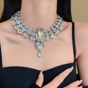 Detailed view of the oversized rhinestone necklace featuring heart and teardrop pendants.