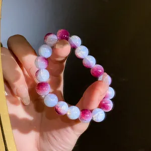 Dettaglio delle perle in vetro craquelé sfumato su questo elegante bracciale elastico