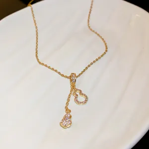 Detailed view of gold calabash tassel necklace with sparkling zircon inlay