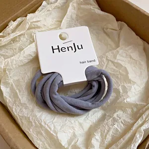 Gros plan sur des élastiques à cheveux gris à haute élasticité sur carte de marque