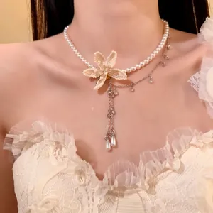 Close-up of elegant double-layered pearl necklace with beaded flower and crystal drops
