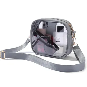 Detail view of a clear PVC crossbody bag showing capacity for phone and cosmetics.