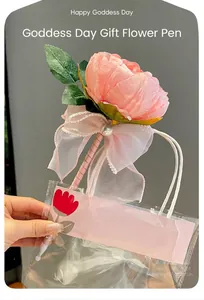 Elegant pink peony flower ballpoint pen with decorative lace bow in clear gift bag.