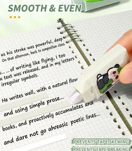 Close-up of a panda-themed correction tape being used smoothly on a grid notebook page.