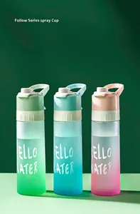 Close-up of three gradient frosted spray water bottles in green, blue, and pink.