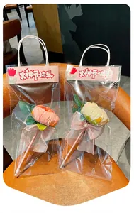 Detail view of creative artificial rose ballpoint pens in elegant clear gift packaging bags