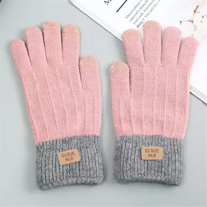 Close-up of pink and gray knit touch screen gloves with warm faux alpaca wool texture.