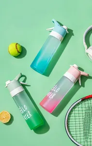 Top view detail of three gradient spray sports water bottles with tennis accessories