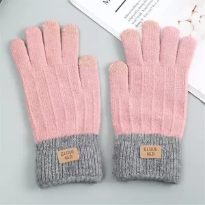 Warm pink and gray knit winter gloves with touchscreen fingertips and a decorative label