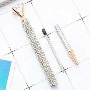 Luxurious rose gold rhinestone ballpoint pen featuring a large crystal diamond top