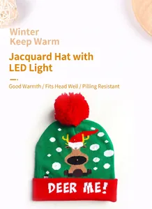 Detailed shot of a festive green knit Christmas beanie featuring LED lights and reindeer