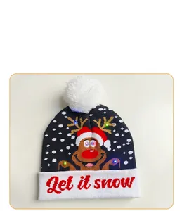 Detail of LED Christmas beanie featuring a reindeer motif and "Let it snow" text.