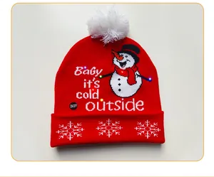 Close-up of red knitted Christmas beanie featuring LED lights and snowman design
