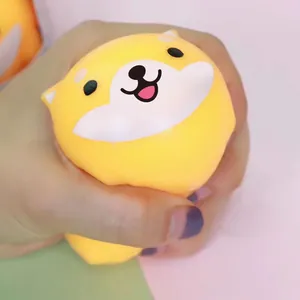 Cute yellow Shiba Inu squishy stress relief toy being squeezed by hand for therapy