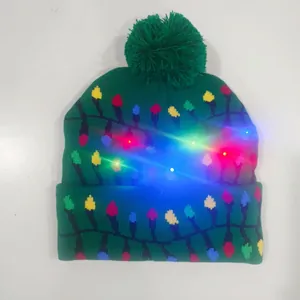 Detail showing glowing colorful LED lights on festive green knitted Christmas beanie