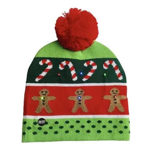 Warm knitted Christmas LED beanie hat with red pom-pom and gingerbread patterns