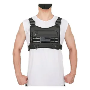 Front view detail of a black multifunctional tactical chest rig worn by a male model.