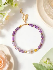 Macro detail of natural amethyst bamboo-joint bracelet featuring a single freshwater pearl