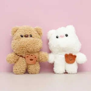 Cute brown and white plush bear keychains with mini bear-paw bags