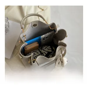 Detailed interior view of a large cream-colored bucket bag showing its capacity.
