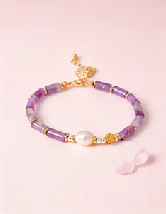 Close-up of natural amethyst bamboo joint bracelet with freshwater pearl and butterfly charm