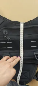 Close-up detail showing the vertical height measurement of the black tactical chest bag