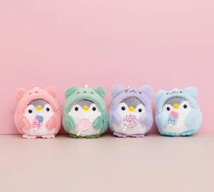 Cute plush penguin keychain charms in pastel colors with candy accessories