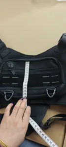 Detailed measurement of a black waterproof tactical chest bag with a flexible tape measure