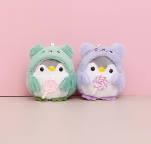 Pair of cute plush penguin pendants holding pink lollipops in green and purple hoods