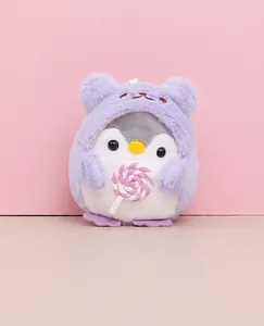 Close-up of a cute plush penguin keychain wearing a purple bear hoodie and lollipop