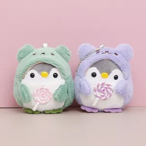 Pair of cute plush penguin keychains wearing colorful animal hoods and holding lollipops