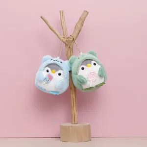 Two adorable plush penguin keychains featuring cute hoods and sweet candy accessories