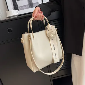 Chic cream-colored large capacity bucket bag featuring a fashion printed strap
