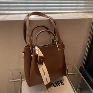 Large brown bucket bag for women with matching inner pouch and white fashion ribbon
