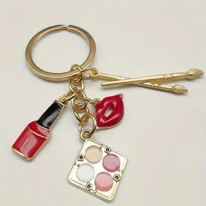 Stylish alloy makeup keychain with lipstick, lips, and eyeshadow palette charms.