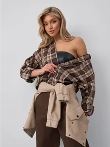 Fashionable retro brown plaid shirt for women styled with a khaki jacket tied around the waist