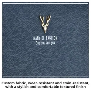 Macro view of blue lychee grain leather with golden deer emblem on women's clutch