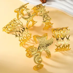 Set of minimalist golden sea-themed cuff bracelets featuring starfish and coral designs
