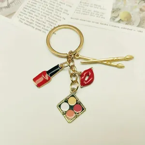 Stylish alloy enamel makeup keychain featuring lipstick, lips, and eyeshadow palette charms