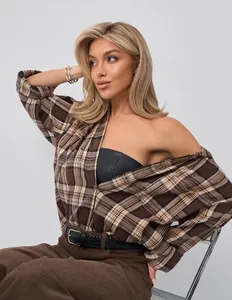 Chic brown plaid shirt styled with a black leather tube top for a retro autumn look.